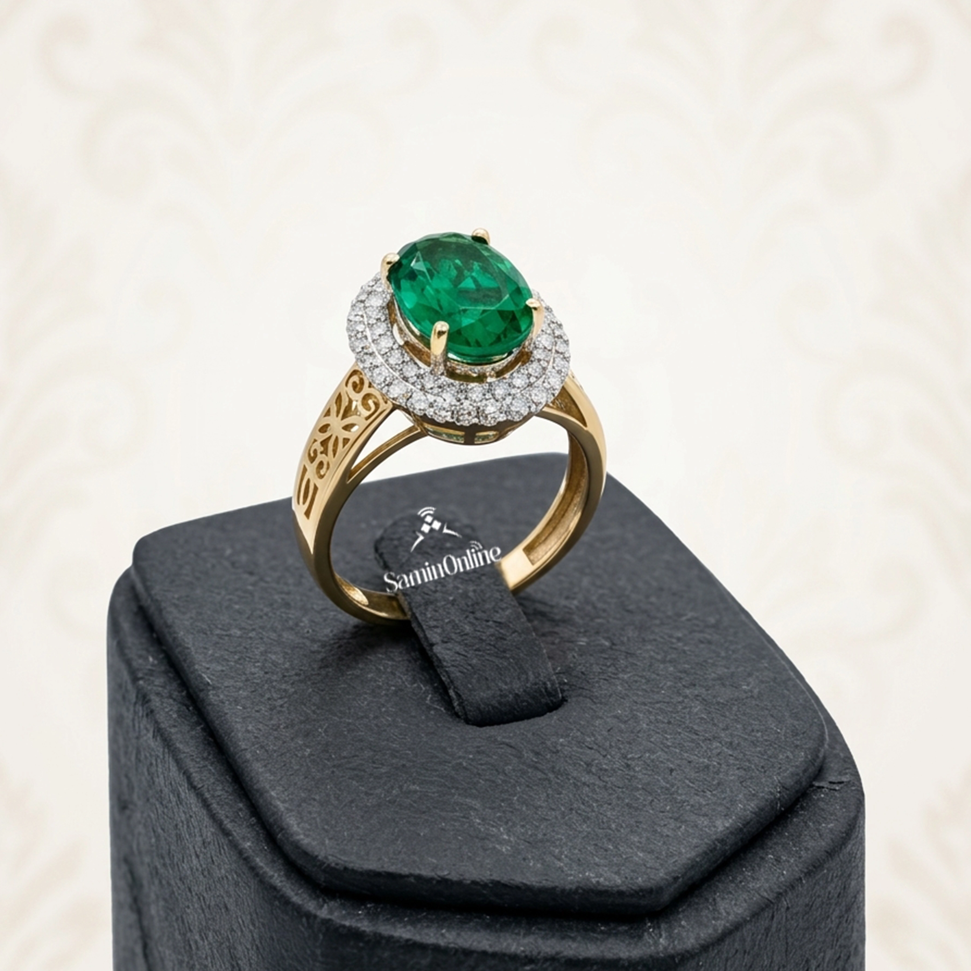 انگشتر طلای 18 عیار زرد مدل 6995 به وزن 4.97 گرم، دارای نگین زمرد بیضی‌تراش در مرکز و 52 قطعه برلیان سفید پاک به وزن 64 سوت در دو ردیف هالو و بدنه اسلیمی.